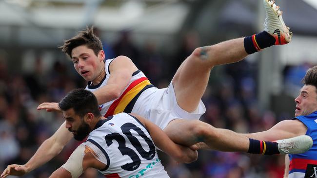 Chayce Jones, one of Crows’ shining lights, flies over a pack on Sunday. Picture: Michael Klein