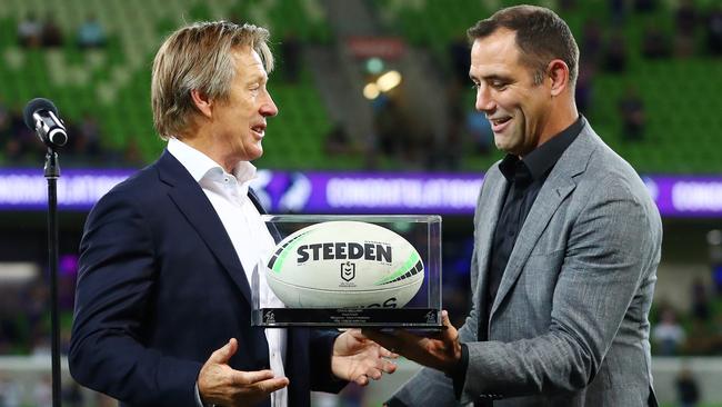 Cameron Smith hands the game ball to Storm coach Craig Bellamy after coaching his 500th NRL game. Picture: Kelly Defina/Getty Images