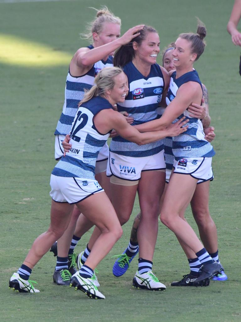 Maddie Boyd gets swamped by teammates after kicking the first ever goal for the Geelong AFLW team in the Geelong Cats v Collingwood Magpies AFLW game at GMHBA Stadium. Picture: Stephen Harman