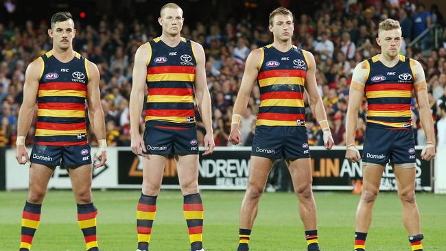 Adelaide players stand for the national anthem. Picture: Michael Klein