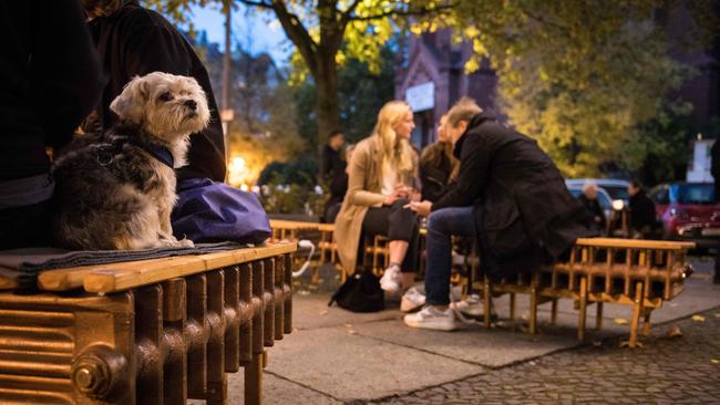 Guests sit on converted heaters in the outdoor area of the restaurant Maerz in the Prenzlauer Berg district of Berlin over the weekend. The restaurant has closed its interior and built a heating system so guests can sit outside in winter. Picture: AFP