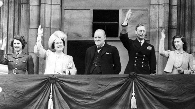 Britain's Prime Minister Winston Churchill, centre, looks on, as King George VI, Queen Elizabeth (later known as the Queen Mother), Princess Elizabeth, left, and Princess Margaret, right, wave to crowds gathered below from the balcony of Buckingham Palace on VE Day. Picture: AP Photo