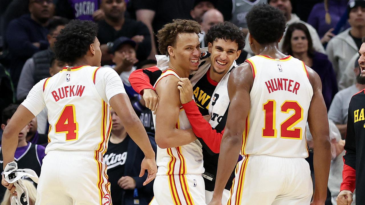 Daniels is congratulated by teammates, before being led off court with his hands held behind his back as the game-winning ball “thief”. Picture: Ezra Shaw/Getty Images/AFP