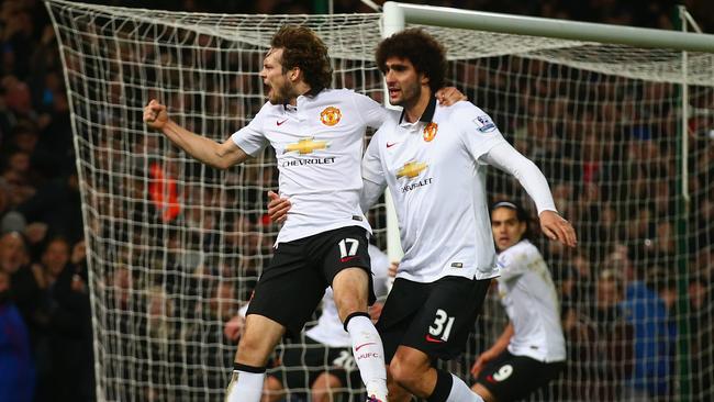 LONDON, ENGLAND - FEBRUARY 08: Daley Blind of Manchester United celebrates scoring their first goal with Marouane Fellaini of Manchester United during the Barclays Premier League match between West Ham United and Manchester United at Boleyn Ground on February 8, 2015 in London, England. (Photo by Clive Rose/Getty Images)