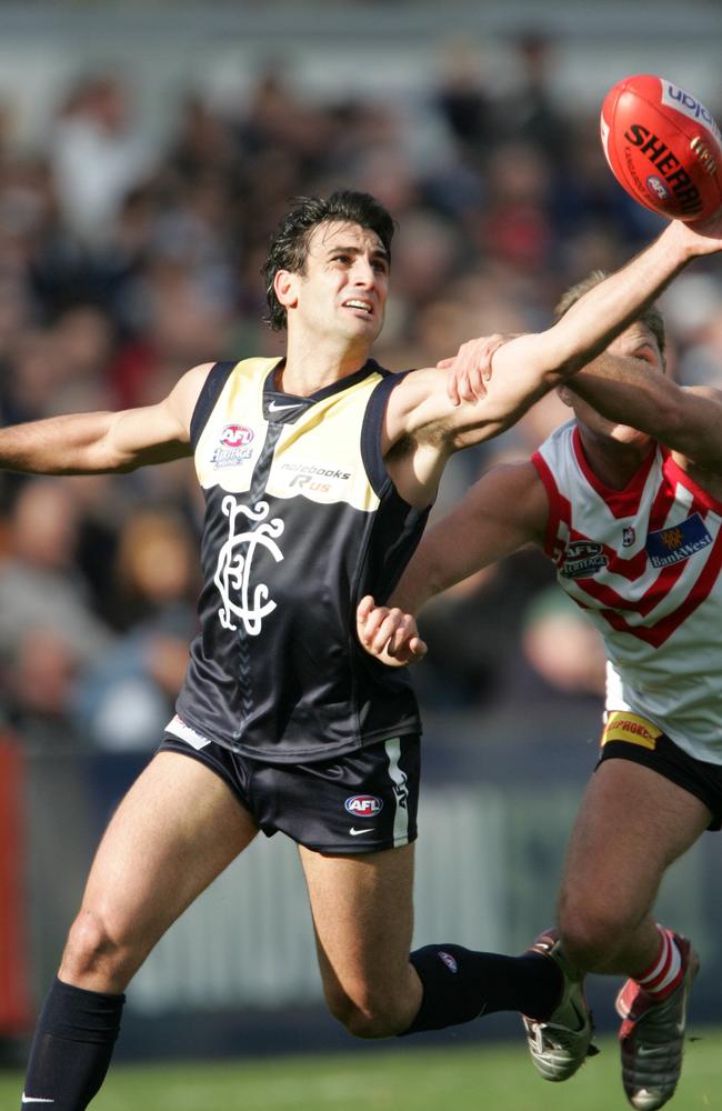 Scott Camporeale wears a heritage Carlton strip in 2004 that features the white shoulders seem on the club’s guernseys from 1980  to 1907 and the CFC logo seen between 1910 and 1926. Picture: News Corp Australia