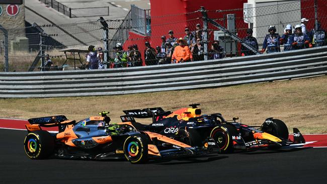 Max Verstappen races ahead of Lando Norris on the opening lap. Photo by ANGELA WEISS / AFP.