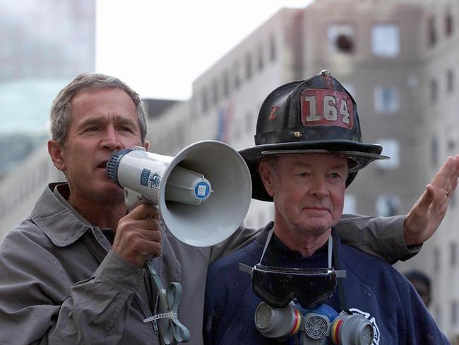 George Bush stands next to retired firefighter Bob Beckwith, 69, as he surveys the damage at the site of the World Trade Center in New York on the seventh anniversay of the terrorist attacks. Picture: Paul J. Richards