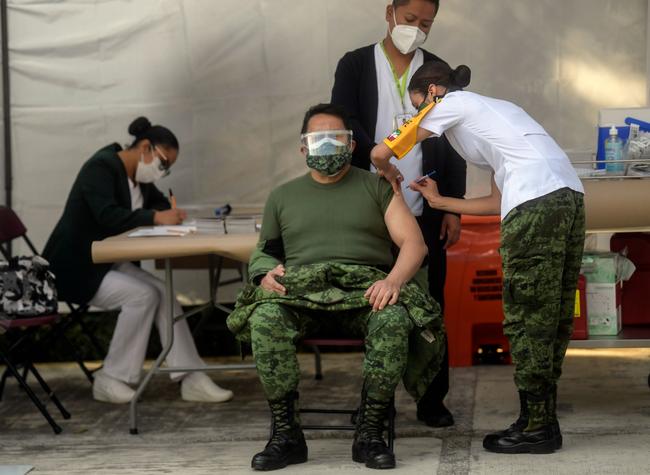 A Mexican soldier medical receives the Pfizer/BioNTech COVID-19 vaccine jab at the General Hospital in Mexico City on Christmas Eve. Picture: AFP