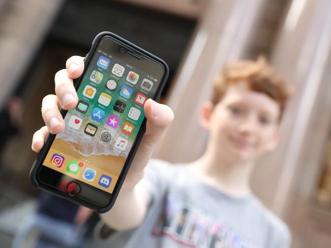 Alex Dellamattea (12) with his new phone. People attend the release of te new Apple iPhone 8 at the Brisbane city store.  Pic Peter Wallis