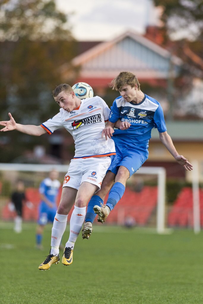 Carter Glockner (left) of Lions FC and Daniel Weber of South West Queensland Thunder compete in NPL Queensland men round 22 football at Clive Berghofer Stadium, Saturday, July 28, 2018. Picture: Kevin Farmer