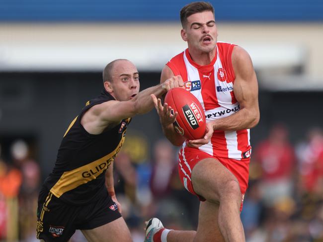 SANFL Round-6 Glenelg v North Adelaide Alex Martini gets his fist to the ball to spoil Noah Casalini Picture: Cory Sutton