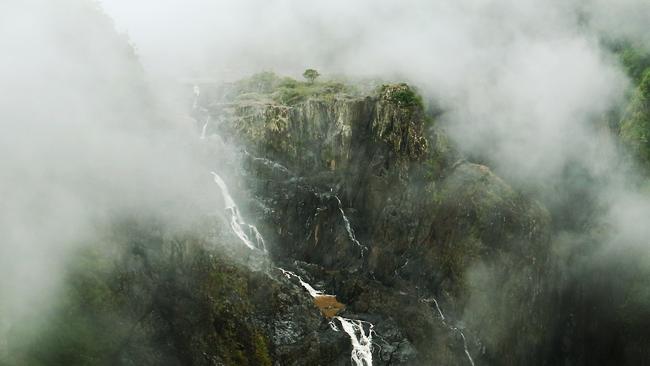 Barron Falls at Kuranda is shrouded in mist and rain clouds at the start of the wet season in Cairns and Far North Queensland. PICTURE: BRENDAN RADKE