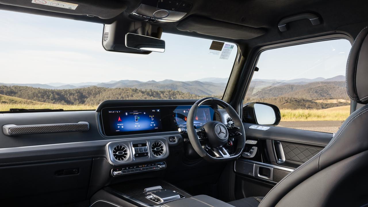 The interior of the 2025 Mercedes-AMG G 63 has been updated to feature the MBUX system, temperature controlled cup holders, wireless charging and a new generational steering wheel. Picture: Mercedes-Benz Australia