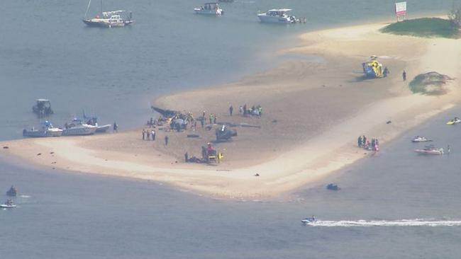 One of the helicopters managed to land on a sandbank near Sea World. Picture: 9 News