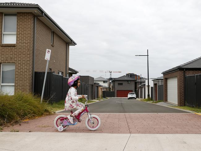 Alisha Bashir, 4, riding her bike home in Bardia a suburb in southwest of Sydney. Her dad Bashir Uddin would like to see more trees in the area. Picture: Jonathan Ng