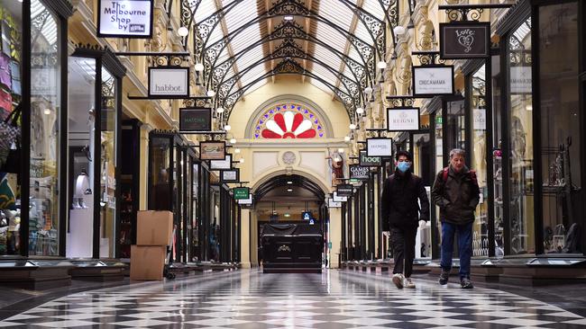 People walk through a usually bustling shopping arcade in Melbourne.