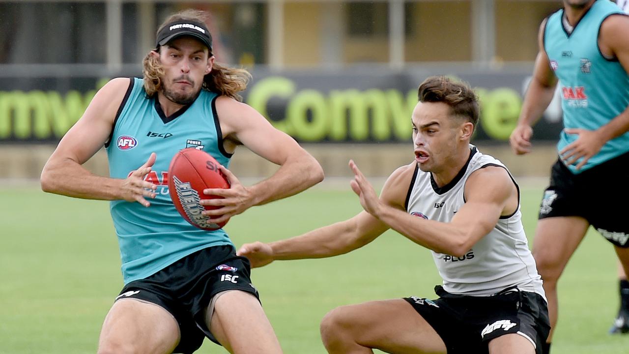 Jarrod Lienert tries to evade Karl Amon at Port Adelaide training at Alberton. Picture: Naomi Jellicoe