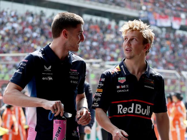 SHANGHAI, CHINA - MARCH 23: Jack Doohan of Australia and Alpine F1 and Liam Lawson of New Zealand and Oracle Red Bull Racing talk on the drivers parade prior to the F1 Grand Prix of China at Shanghai International Circuit on March 23, 2025 in Shanghai, China. (Photo by Mark Thompson/Getty Images)