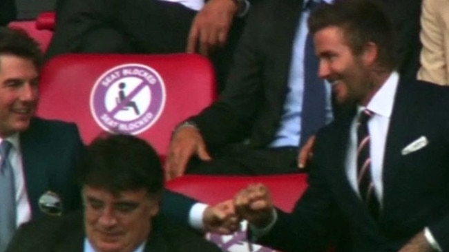 Tom Cruise, left, fist bumps with his mate David Beckham at the football final at Wembley. Picture: Supplied