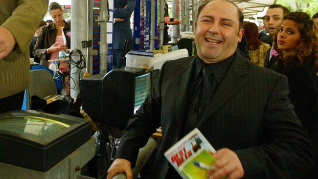 2004: Mokbel sharing a laugh with bookies at Flemington during the Oaks.