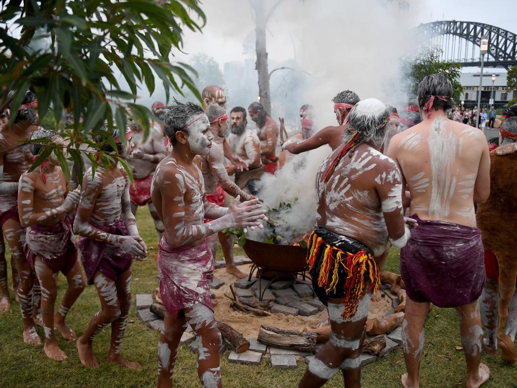 Koomurri people and representatives of aboriginal groups from around Australia perform the Smoking Ceremony and Dance during the WugulOra Morning Ceremony at Walumil Lawn at Barangaroo Reserve as part of Australia Day celebrations in Sydney. Picture: AAP Image/Brendan Esposito