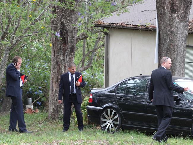 Detectives search the Oakville property for clues after Det Insp Anderson’s murder.