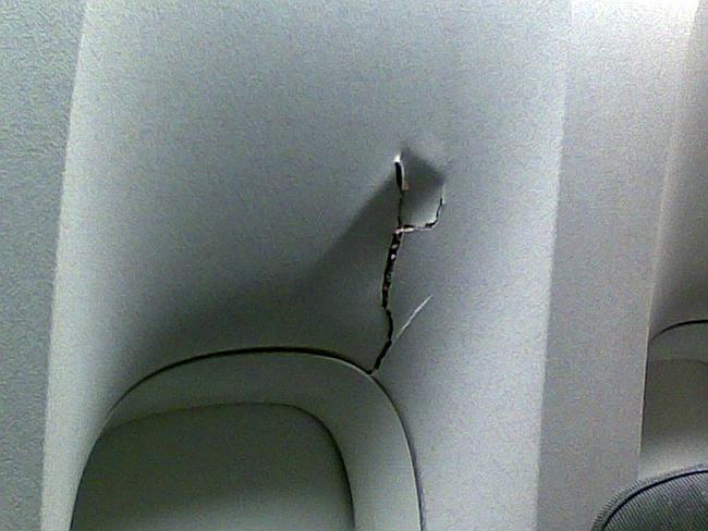 A passenger hit her head hard enough to crack this overhead panel on a United Flight 967, after it experienced severe turbulence en route from Washington, D.C., to Los Angeles in 2010.  