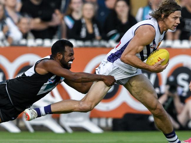 Nat Fyfe is tackled by Willie Rioli at Alberton on Friday night. Photo: Mark Brake/Getty Images.