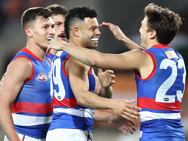 CANBERRA, AUSTRALIA - APRIL 23: Jason Johannisen of the Bulldogs celebrates kicking a goal with team mates during the round six AFL match between the Greater Western Sydney Giants and the Western Bulldogs at Manuka Oval on April 23, 2021 in Canberra, Australia. (Photo by Cameron Spencer/Getty Images)