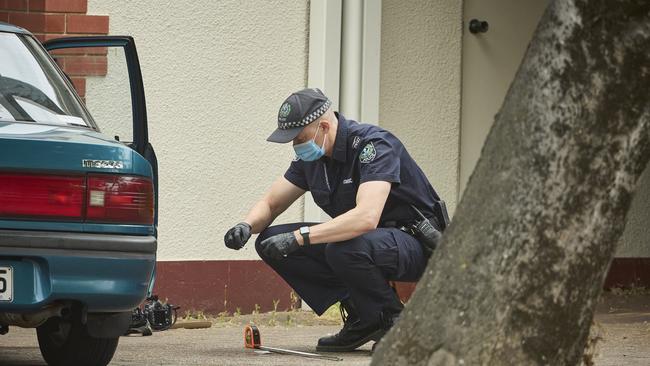 A police officer investigates after a car slammed into a yoga studio on South Terrace. Picture: Matt Loxton