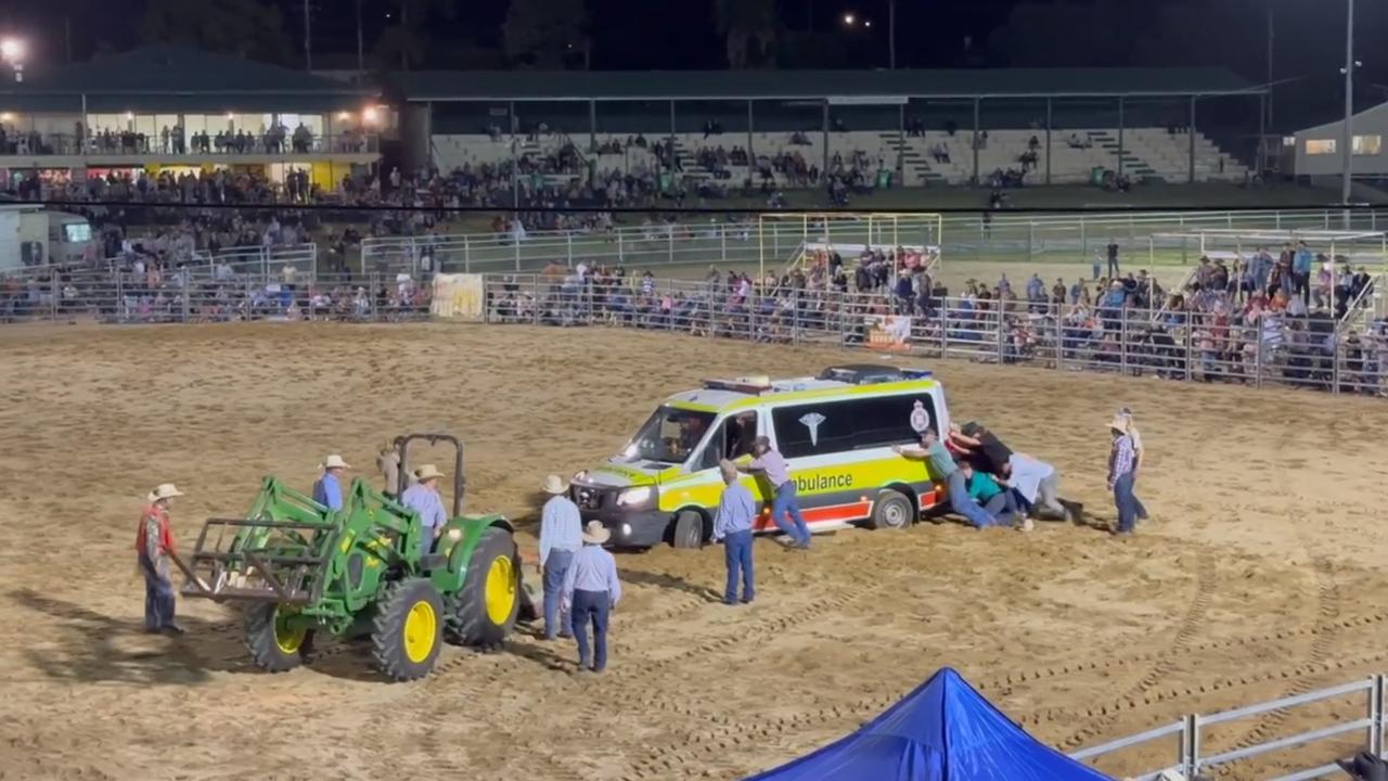 An ambulance is towed out of the arena at the Warwick New Year's Eve Rodeo after a 25-year-old cowboy was critically injured while riding a bull at the event. He later died in hospital.