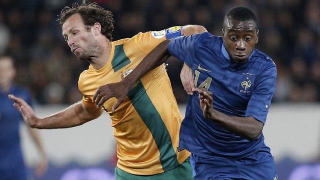 France's Blaise Matuidi blows by Socceroos skipper Lucas Neill.