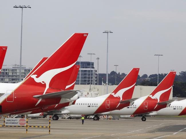 The tails of Qantas planes are lined up at Sydney Airport in Sydney, Sunday, Oct. 30, 2011. Qantas Airways grounded all of its aircraft around the world indefinitely Saturday due to ongoing strikes by its workers. (AP Photo/Rick Rycroft)