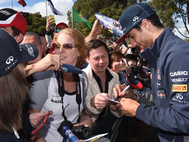 Red Bull driver Daniel Ricciardo of Australia signs autographs for the fans at the Formula One Australian Grand Prix in Melbourne. Picture: AFP/William West
