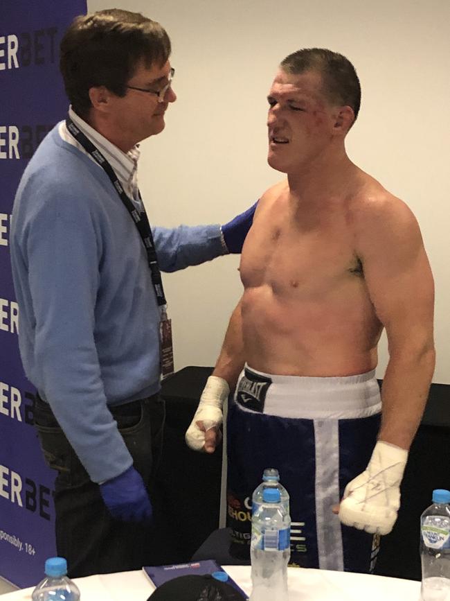 Doctor Alan Saunders attends to Paul Gallen after his fight with Justis Huni.