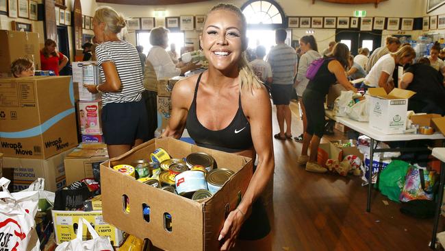 Volunteer Christie Swadling of Cronulla brings in more donations. Bondi Surf Bathers Life Saving Club has been inundated with donations after setting up as a bushfire relief centre. Picture: John Appleyard