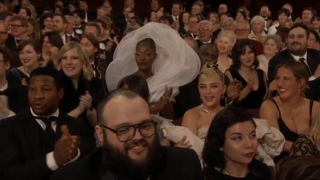 Imagine finally scoring an invite to the Oscars – and being seated behind her.