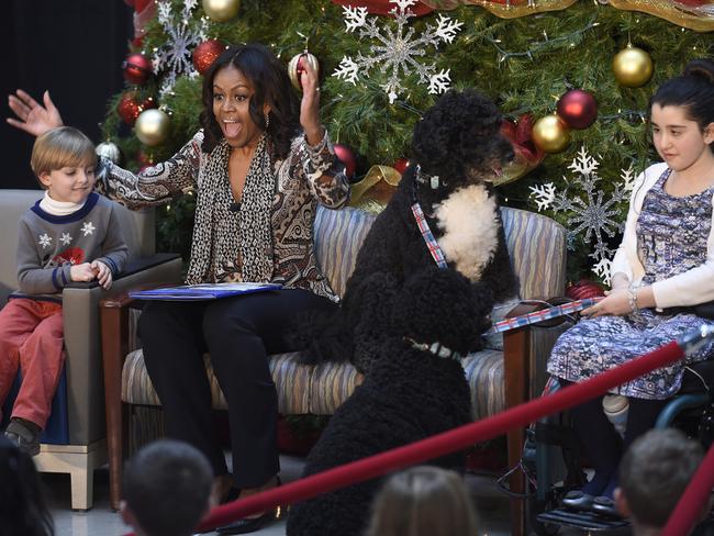 Old tradition ... Michelle Obama reads Twas the Night Before Christmas at the Children’s National Health System in Washington on December 14. Picture: AP Photo/Susan Walsh