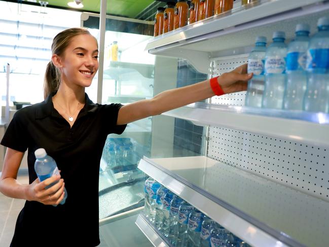 Food and beverage trainee Kiara Moro stocks up the drinks in preparation for the stadium’s opening.