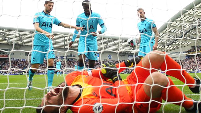 Spurs players rush to aid a stricken Hugo Lloris.