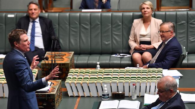 Attorney-General Christian Porter jumps his own shark as Scott Morrison checks his phone during the final question time of 2020. Picture: Getty Images