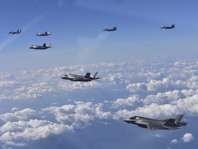 F-35 stealth fighter jets and F-15 fighter jets fly over the Korean Peninsula. Japan has begun a major expansion and upgrade of its military capabilities. Picture: AP