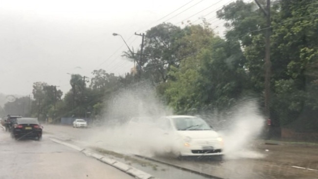 An increase in rainfall about 3.40pm on Friday saw hazardous driving conditions as water overflowed drains along Pittwater Rd, North Manly. Picture: Jim O’Rourke