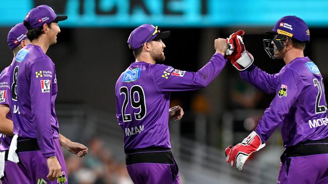 Dawid Malan of the Hurricanes celebrates with teammates after taking the catch to dismiss Sam Heazlett of the Heat during the Big Bash League match between the Brisbane Heat and the Hobart Hurricanes at The Gabba, on December 27, 2020, in Brisbane, Australia. (Photo by Bradley Kanaris/Getty Images)