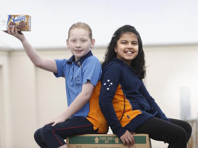 Girl Guides Tasmania will be donating Girl Guide biscuits to the FoodBank picture of girl guides with box.s of biscuits from left, Sarah Potter 9 and Meerab Fatimah 9, picture ;KIM EISZELE