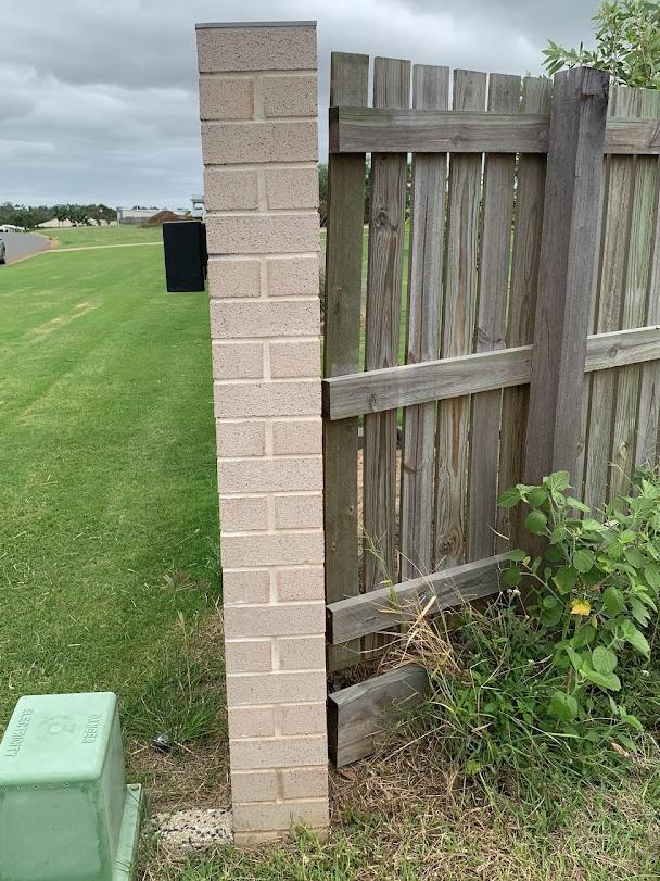 The fence pillar at the end has come away from the adjoining fence line.