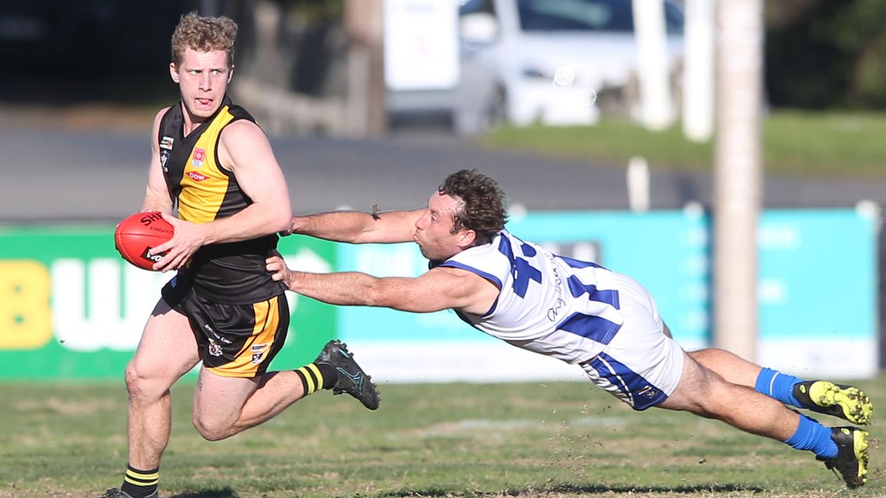 Anglesea's Luke Rounds (43) hangs off the shirt-tails of Torquay's James Darke (60). Torquay v Anglesea BFL senior game at Spring Creek on Saturday. Picture: Alan Barber