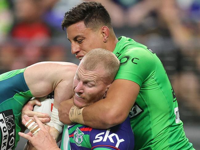 LAS VEGAS, NEVADA - MARCH 01: Mitchell Barnett of the Warriors is tackled by Hudson Young and Joseph Tapine of the Raiders during the round one NRL match between the Canberra Raiders and the New Zealand Warriors at Allegiant Stadium on March 01, 2025, in Las Vegas, Nevada. (Photo by Ezra Shaw/Getty Images)