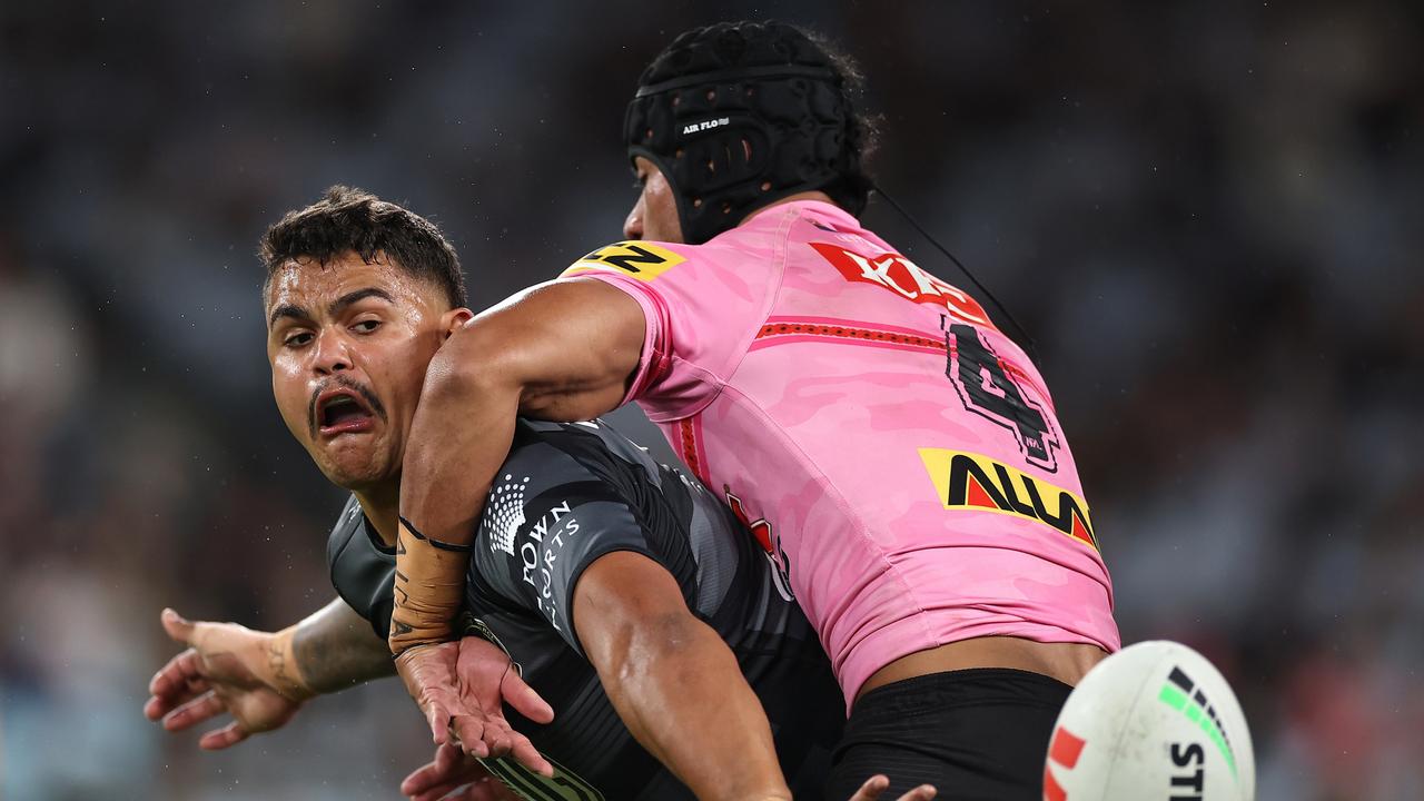 Latrell Mitchell of the Rabbitohs is tackled by Stephen Crichton of the Panthers during the round eight NRL match between South Sydney Rabbitohs and Penrith Panthers at Accor Stadium on April 20, 2023 in Sydney, Australia. (Photo by Cameron Spencer/Getty Images)