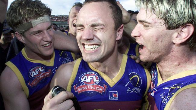 Aust footballer Luke Power (l) celebrating with Shaun Hart (c) and Jason Akermanis (r).AFL football - Brisbane Lions vs Essendon bombers grand final match at the MCG 29 Sep 2001./Football/AFL